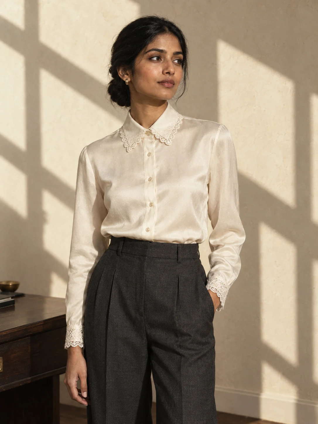 AI-created adult Indian model in an ivory blouse and tailored trousers